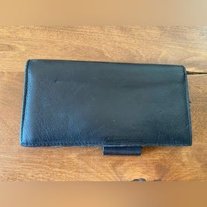 Leather checkbook cover with pen loop.